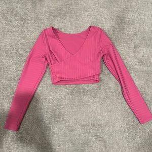 Lululemon pink cross long sleeved cropped top